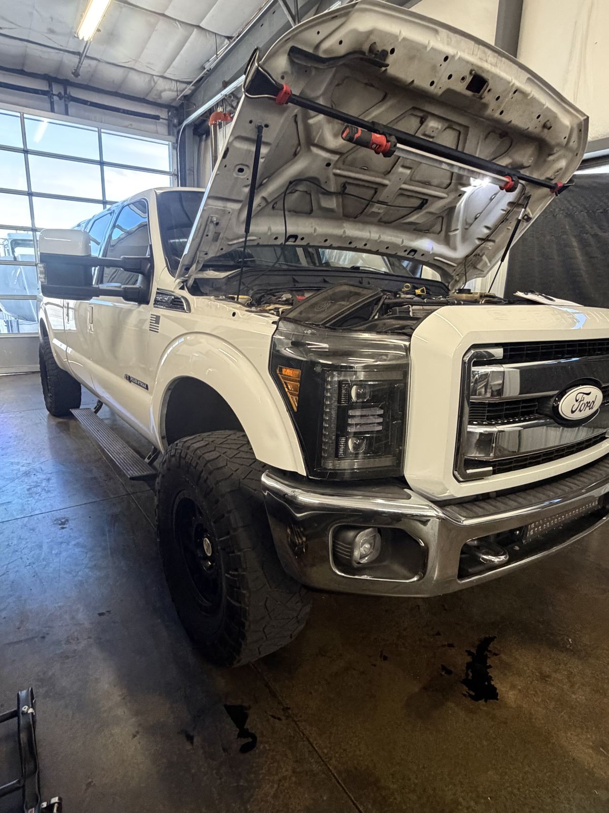 Ford Powerstroke truck with the hood open at Modern Diesel Solutions